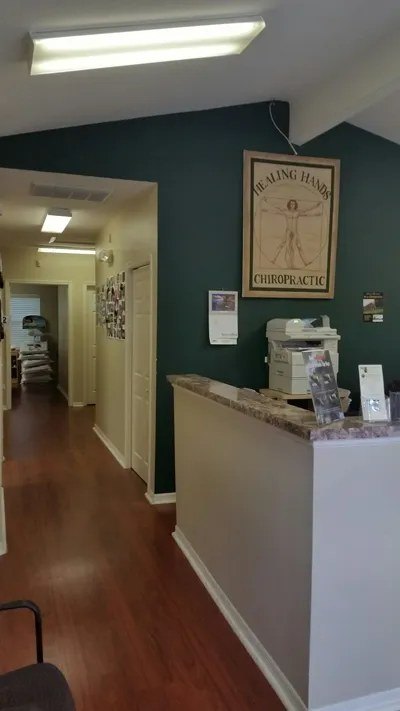 Front desk with the Healing Hands logo